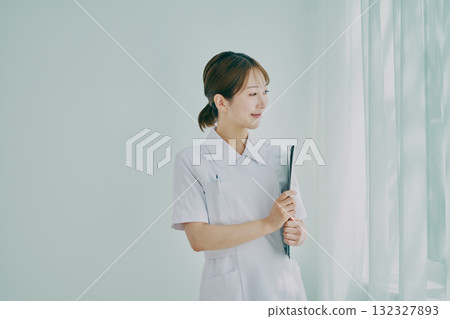 Female nurse standing by the window 132327893