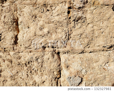 Rough textured adobe or mud brick wall closeup background. Rough textured adobe or mud brick wall closeup background. 132327981