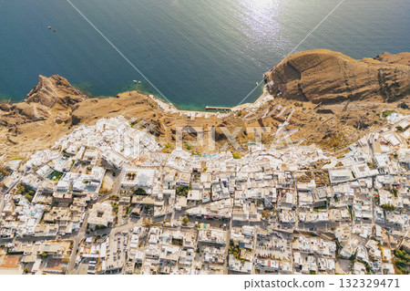 Stunning overhead drone view of the famous white-washed villages and steep cliffs of Santorini Stunning overhead drone view of the famous white-washed villages and steep cliffs of Santorini 132329471