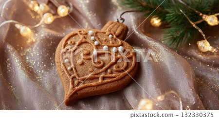 Beautifully decorated cookie shaped like a Christmas ornament, ideal for festive desserts and holiday gatherings 132330375