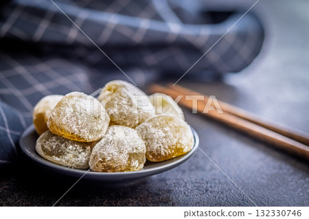 Japanese mochi dessert on plate on black table. Japanese mochi dessert on plate on black table. 132330746