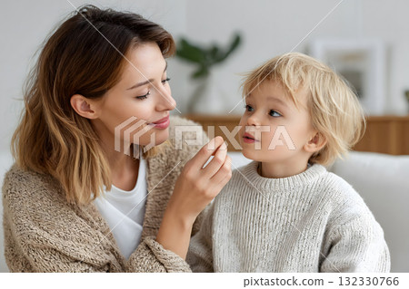 Happy Mother and Child Holding Vitamin Capsules Bottle Happy Mother and Child Holding Vitamin Capsules Bottle 132330766