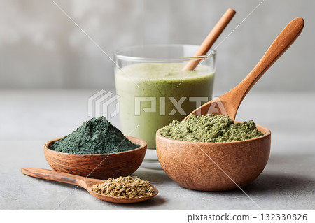 Green Superfood Powder and Smoothie in Wooden Bowls Green Superfood Powder and Smoothie in Wooden Bowls 132330826