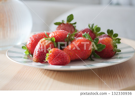 Fresh strawberries on a plate with natural light setting 132330936