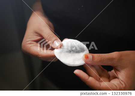 Clean cotton pad showing makeup removal process at home Clean cotton pad showing makeup removal process at home 132330976