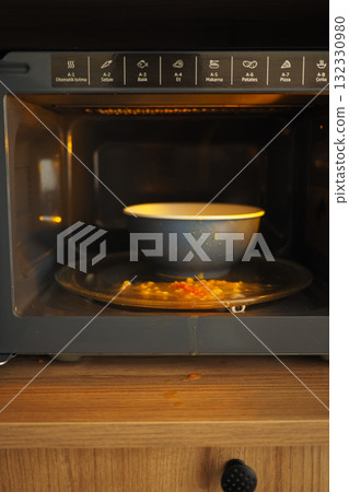 a bowl of food spilled in a microwave oven at home kitchen a bowl of food spilled in a microwave oven at home kitchen 132330980
