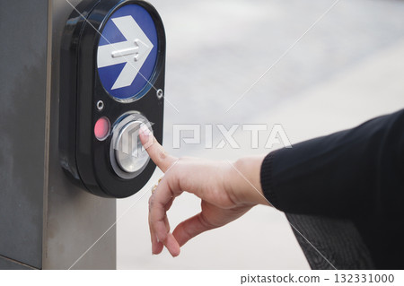 Pedestrian pressing button to cross street safely 132331000