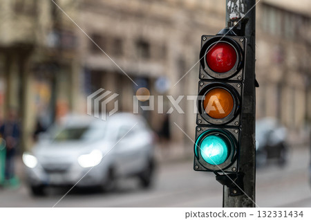 traffic light on the street junction with beautiful bokeh, city with cars in the background 132331434