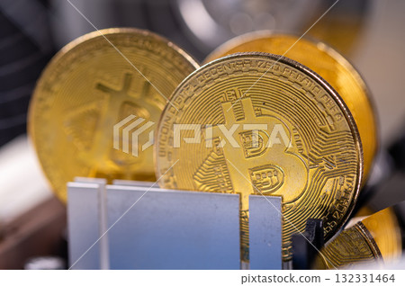 closeup of gold bitcoin on computer components background, technology and digital currency concept 132331464