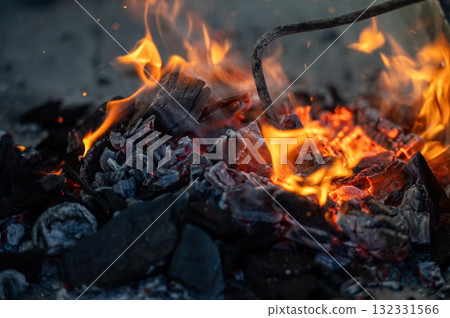 Close up of bonfire with flame and firewood outdoors Close up of bonfire with flame and firewood outdoors 132331566