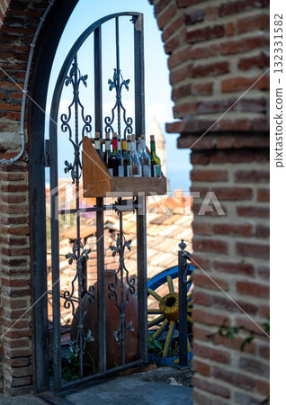 A box of wine bottles at the iron gate of a restaurant in the old part of Sighnaghi town A box of wine bottles at the iron gate of a restaurant in the old part of Sighnaghi town 132331582