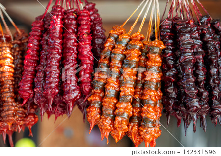 Traditional Georgian food sausage-shaped candy churchkhela hanging in market. Traditional Georgian food sausage-shaped candy churchkhela hanging in market. 132331596