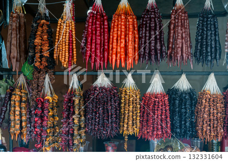 Traditional Georgian food sausage-shaped candy churchkhela hanging in market. Traditional Georgian food sausage-shaped candy churchkhela hanging in market. 132331604