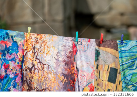 The colorful fabrics and scarfs displayed in a street market. 132331606