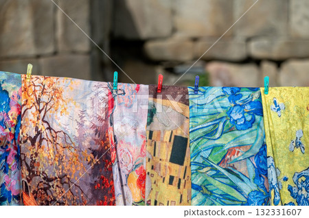 The colorful fabrics and scarfs displayed in a street market. 132331607