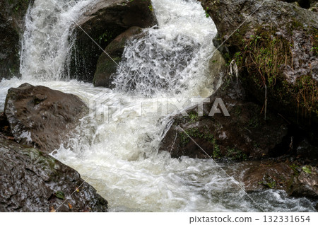 Rapid and powerful water flow between large rocks in cold mountain river, closeup Rapid and powerful water flow between large rocks in cold mountain river, closeup 132331654