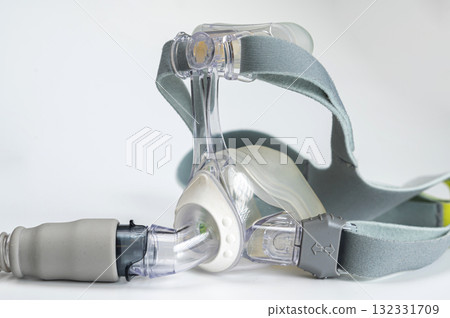 Continuous positive airway pressure- mask (CPAP) and hose isolated on white background Continuous positive airway pressure- mask (CPAP) and hose isolated on white background 132331709