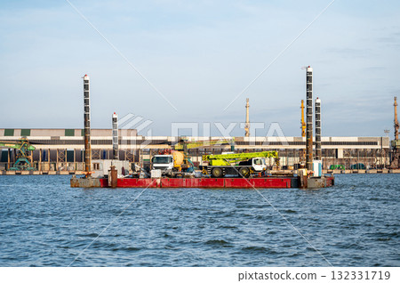 floating platform with crane for hydrotechnical works and concrete mixer trucks on deck floating platform with crane for hydrotechnical works and concrete mixer trucks on deck 132331719