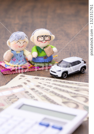 Elderly couple and their car (+ money and calculator) 132331761