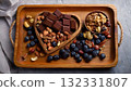 Heart nourishing food, Wooden tray filled with heart-healthy snacks like dark chocolate, 132331807