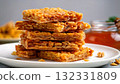 Crispy honey-coated granola bars stacked on a white plate 132331809