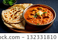 Pakistan food, Freshly baked naan bread with a side of butter and a bowl of rich chicken karahi 132331810