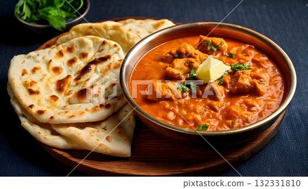 Pakistan food, Freshly baked naan bread with a side of butter and a bowl of rich chicken karahi 132331810