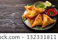 India Street Food, Freshly made samosas with a crispy golden crust, served with mint chutney 132331811