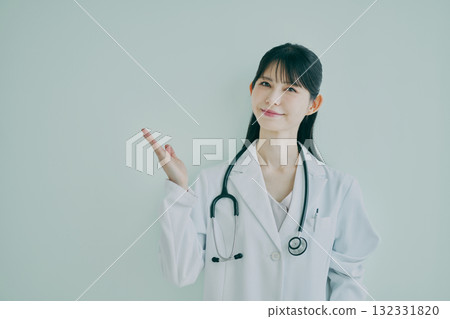 Female doctor raising her right hand 132331820