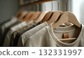 Neutral T-Shirts on Wooden Hangers in a Closet, Minimal Wardrobe Display for Fashion Retail 132331997