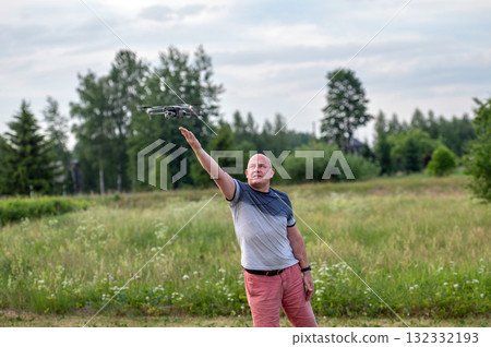 A drone lands on the hand of a man after a successful flight. 132332193