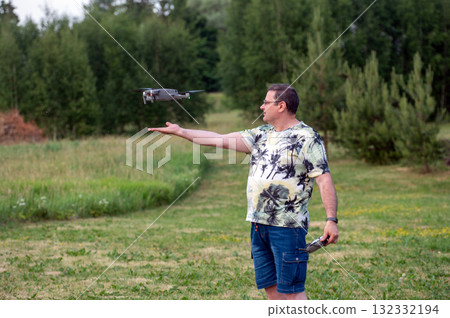 A drone lands on the hand of a man after a successful flight. 132332194