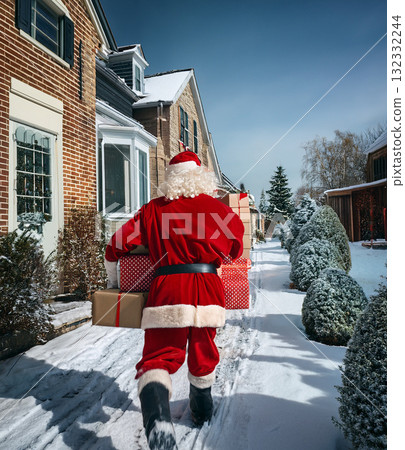 Santa claus delivering christmas gifts on snowy street Santa claus delivering christmas gifts on snowy street 132332244