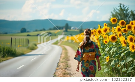 A beautiful woman in a kimono walking through a sunflower field 132332357