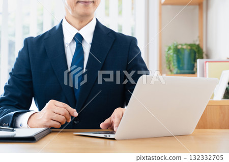 Businessman using a personal computer Businessman using a personal computer 132332705