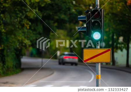 traffic semaphore with green light on defocused background of autumn city, closeup 132333427