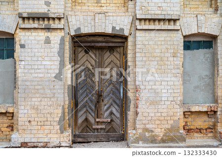 Weathered, old wooden door. Old rough and scratched wooden door. Front view. Weathered, old wooden door. Old rough and scratched wooden door. Front view. 132333430