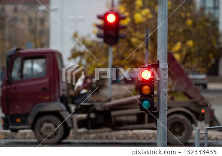 view of city traffic with traffic lights, in the foreground a traffic light with a red light view of city traffic with traffic lights, in the foreground a traffic light with a red light 132333435