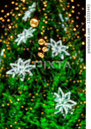 garland of light bulbs on defocused festive lights background, shallow depth of field, copy space garland of light bulbs on defocused festive lights background, shallow depth of field, copy space 132333443