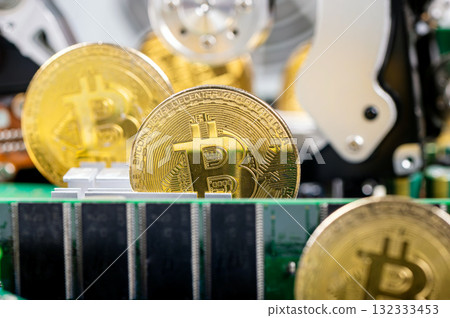 closeup of gold bitcoin on computer components background, technology and digital currency concept 132333453