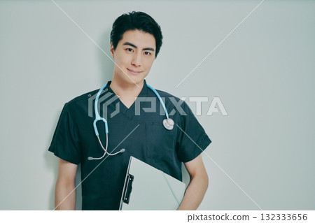 Young man wearing scrubs Young man wearing scrubs 132333656
