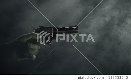 Witch hand with a long black nail holding a handgun with a dark background. Zombie, devil, evil, satan, or monster hand. Concept of Spooky Halloween Witch hand with a long black nail holding a handgun with a dark background. Zombie, devil, evil, satan, or monster hand. Concept of Spooky Halloween 132333940