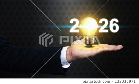 Business hand showing 2026 with a bright light bulb. Happy New Year concept or Celebration Business hand showing 2026 with a bright light bulb. Happy New Year concept or Celebration 132333971