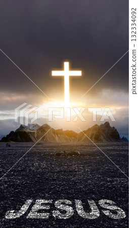 Light of the Christian cross on the hill with Jesus text on the field with dark dramatic sky background. Concept of Christianity, religious, faith, Jesus, or belief Light of the Christian cross on the hill with Jesus text on the field with dark dramatic sky background. Concept of Christianity, religious, faith, Jesus, or belief 132334092