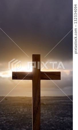 Christian cross with landscape view and dark dramatic sky background. Concept of Christianity, religious, faith, Jesus, or belief 132334094