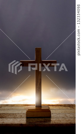 Christian cross on a wooden table with a dark dramatic sky background. Concept of Christianity, religious, faith, Jesus, or belief 132334098