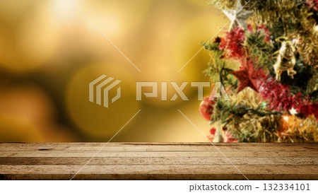 Wooden table and colorful Christmas tree decorations ornamented with blurred bokeh lights. Mockup or Copy space. Holiday greetings or winter themes. Concept of the Merry Christmas celebration 132334101