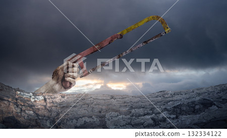 Zombie hand with wounds and blood holding a handsaw behind a tree bark surface with dark and dramatic cloudscape background. Zombie, devil, evil, satan, or monster hand. Concept of Spooky Halloween Zombie hand with wounds and blood holding a handsaw behind a tree bark surface with dark and dramatic cloudscape background. Zombie, devil, evil, satan, or monster hand. Concept of Spooky Halloween 132334122