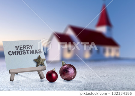 Greeting card of Merry Christmas with Christmas ornaments on the field with a church background. Holiday greetings or winter themes. Concept of the Merry Christmas celebration Greeting card of Merry Christmas with Christmas ornaments on the field with a church background. Holiday greetings or winter themes. Concept of the Merry Christmas celebration 132334196