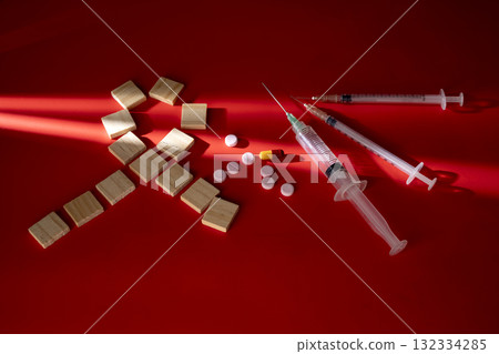 Ribbon formed by wooden cubes with a syringe and medicine. Symbolizing awareness and support for HIV or AIDS patients. Mockup or Copy space. World Aids Day. Concept of Healthcare and Medicine Ribbon formed by wooden cubes with a syringe and medicine. Symbolizing awareness and support for HIV or AIDS patients. Mockup or Copy space. World Aids Day. Concept of Healthcare and Medicine 132334285